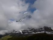Cloud obscures a snowy peak