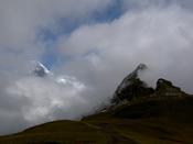Snowy peak in the distance peeks from the clouds