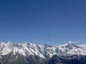 Helicoptor flies over a mountain range