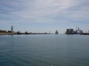 A boat leaves the port