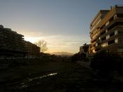 The sun sets, casting a haze